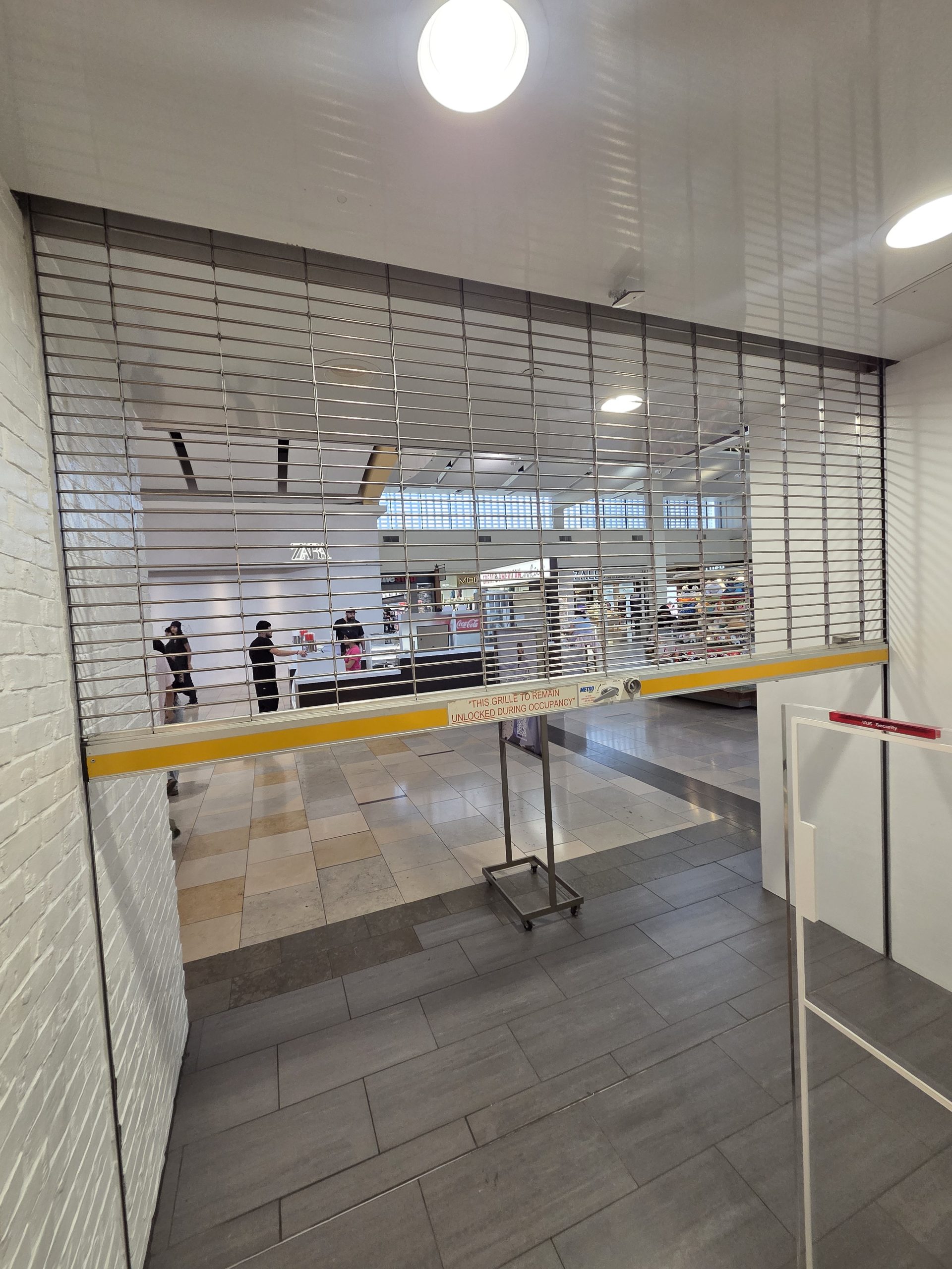 Why Commercial Rolling Security Grilles Must Remain Unlocked During Occupancy