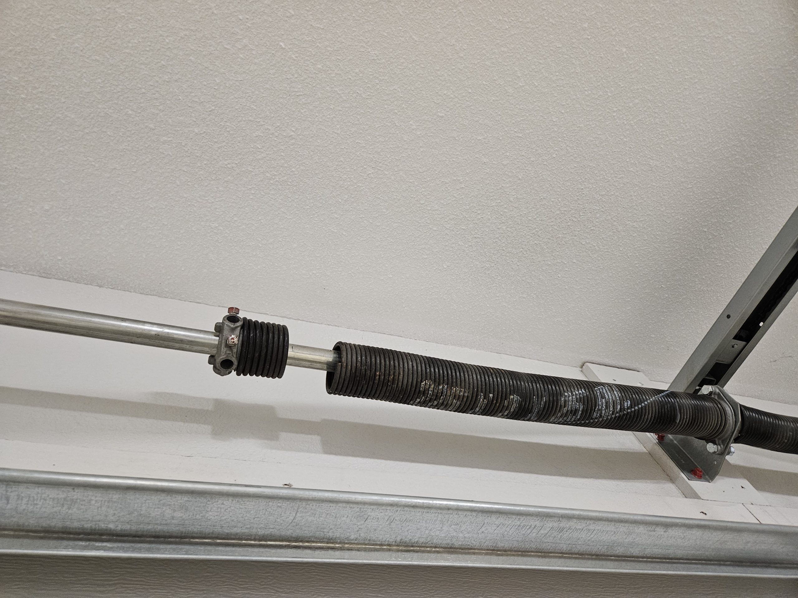 Why Did My Garage Door Torsion Spring Break? Understanding and Addressing This Critical Issue