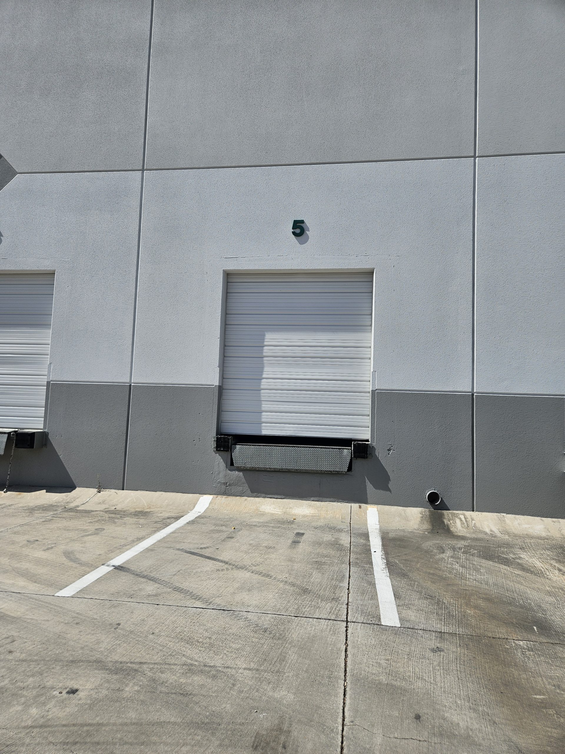 What is a Commercial Loading Dock Door and How Does a Dock Leveler Work?