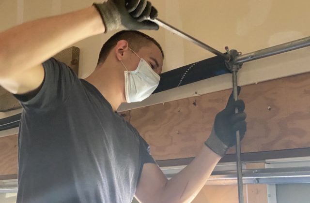 garage-door-repairman-wearing-mask-while-working-on-garage-door-spring_t20_N0xgRd.jpg garage-door-repairman-wearing-mask-while-working-on-garage-door-spring_t20_N0xgRd.jpg